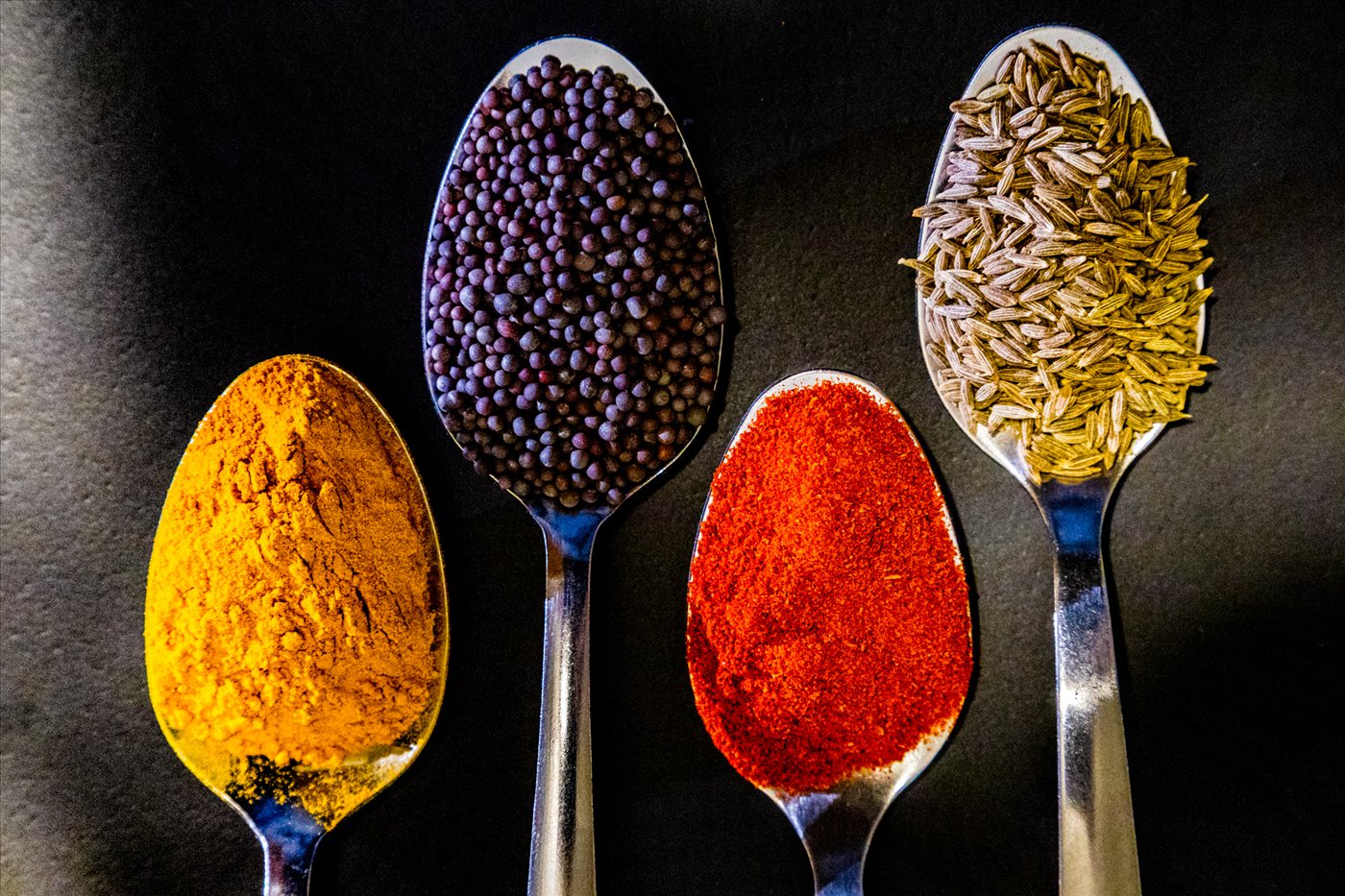 Assorted Indian whole and ground spices arranged in bowls